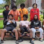 A group of young men posing for the camera outside