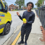 A teen smiling with his italian ice