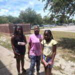 Three teens smiling outside