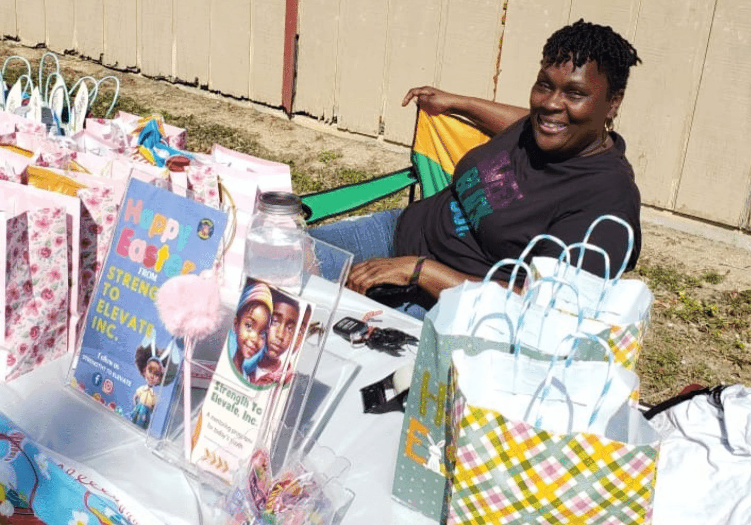 Founder sitting at a table with Easter supplies smiling Founder sitting at a table with Easter supplies smiling